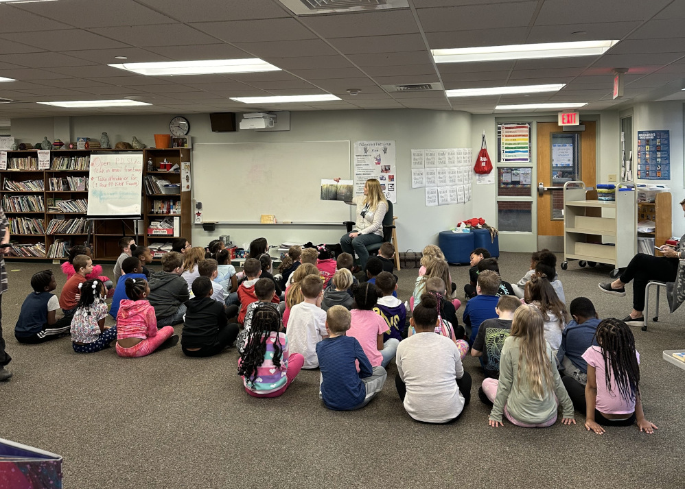 Library staff reading to a school group.